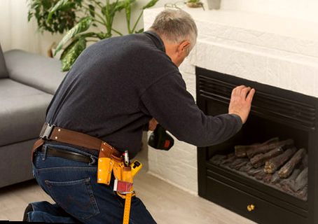 Technician mounting an insert into a white mantel
